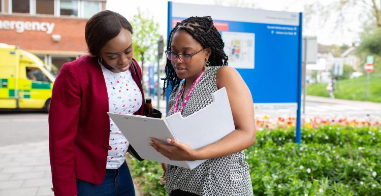 Women talking outside hospital