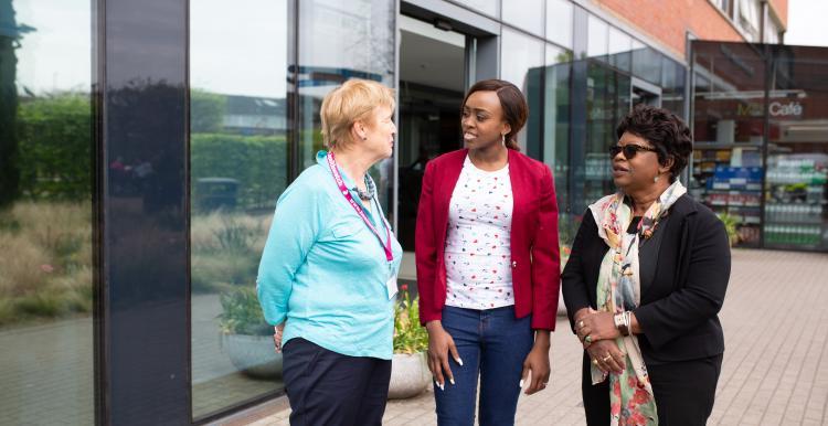 ICS image Photo of three women talking outside a hospital or health centre