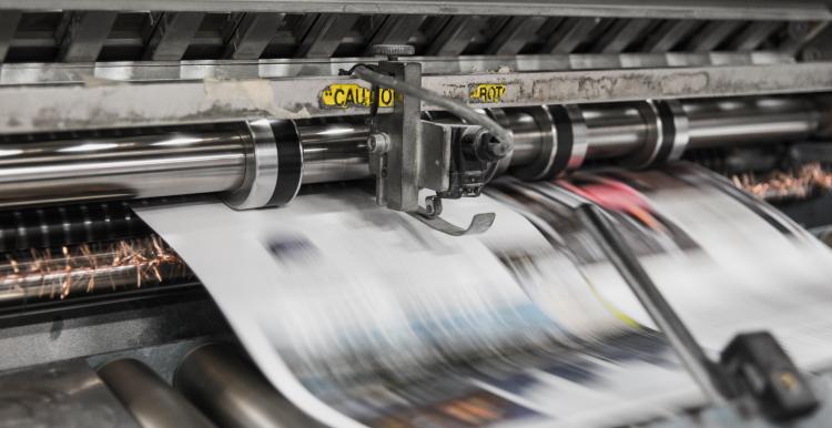 Photo of newspapers being printed