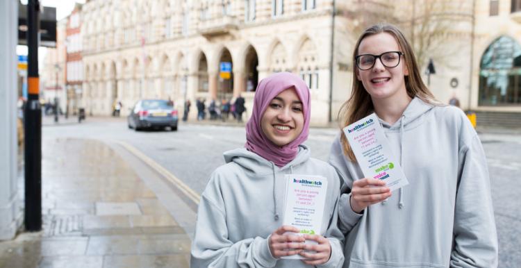two young volunteers with leaflets