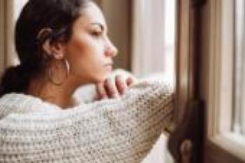 Young woman looking out of the window