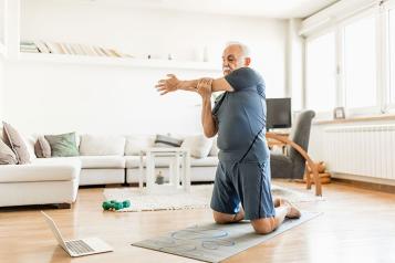 Man exercising at home online