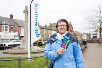 woman with healthwatch leaflet