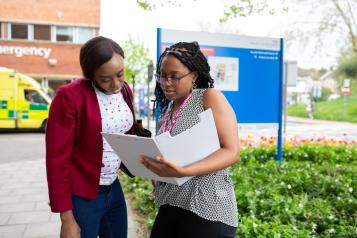 Women talking outside hospital