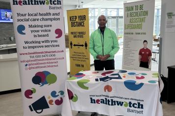 Healthwatch Barnet representative at Stay Well event with banner