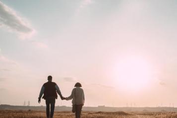 Couple holding hands in the sunset