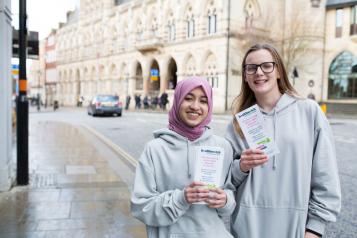 two young volunteers with leaflets