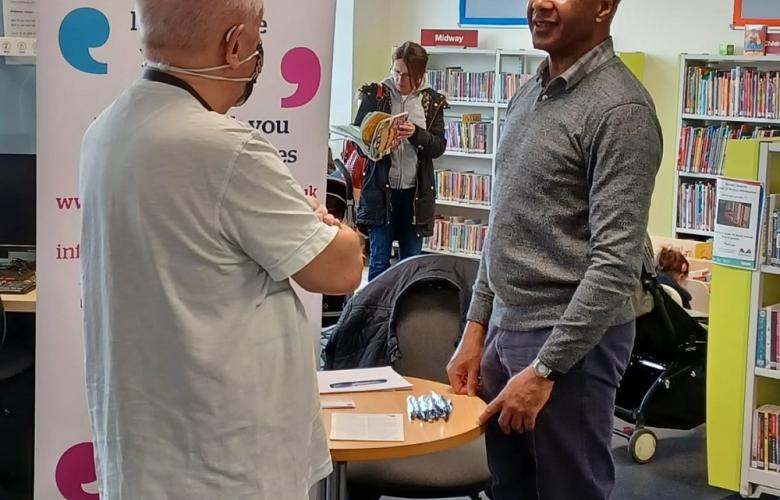 Healthwatch Barnet staff talking to member of the public New Barnet Library