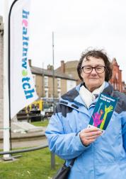 woman with healthwatch leaflet