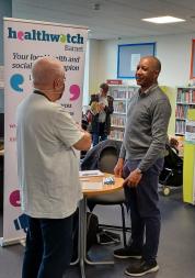 Healthwatch Barnet staff talking to member of the public New Barnet Library