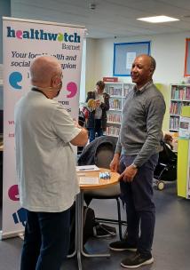Healthwatch Barnet staff talking to member of the public New Barnet Library